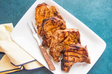 Grilled Pork Chops on Plate with Carving Fork